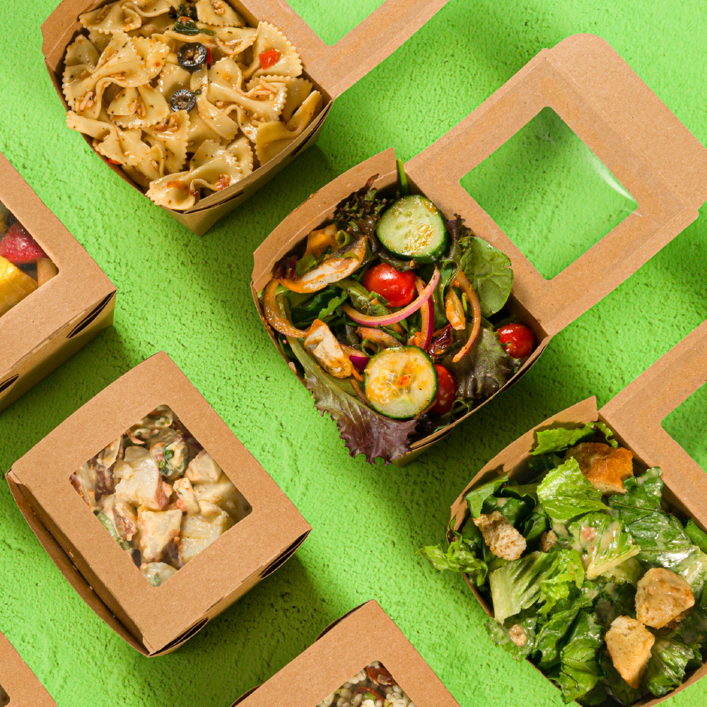 Close-Up of Side Salad Options Pasta Salad, Green Garden Salad, & Caesar Salad in open boxes, available at Freson Bros. Fresh Market Kitchens